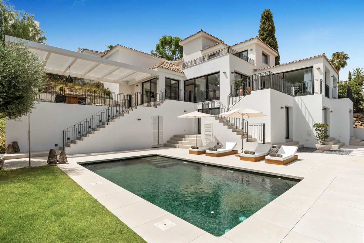 Private pool in front of the villa’s rear facade with pergola terrace