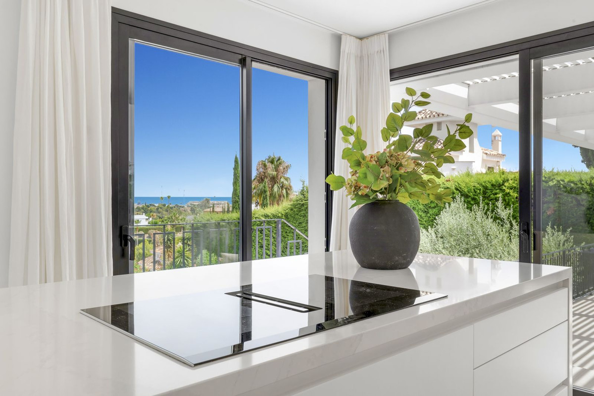 Kitchen island with sea view through open window
