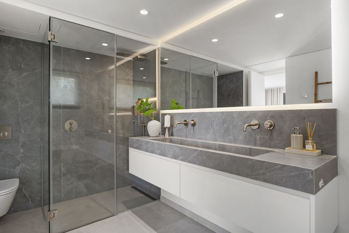 Bathroom with double basins, marble and walk-in shower