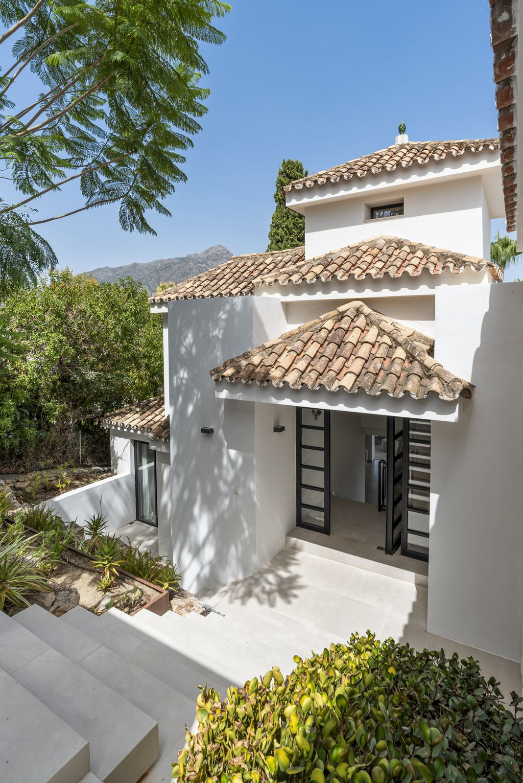 Villa entrance with tiled roofs and La Concha mountain behind