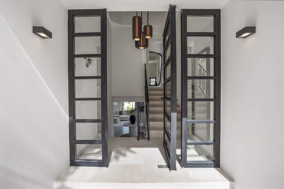 Villa entrance doors with view through to hall and staircase